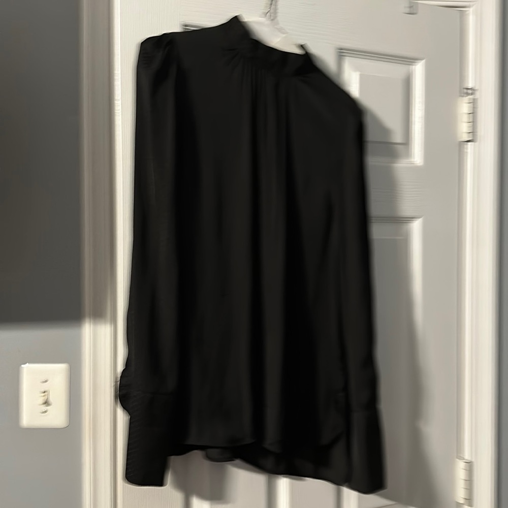 A black dress blouse with cuff and mock neck